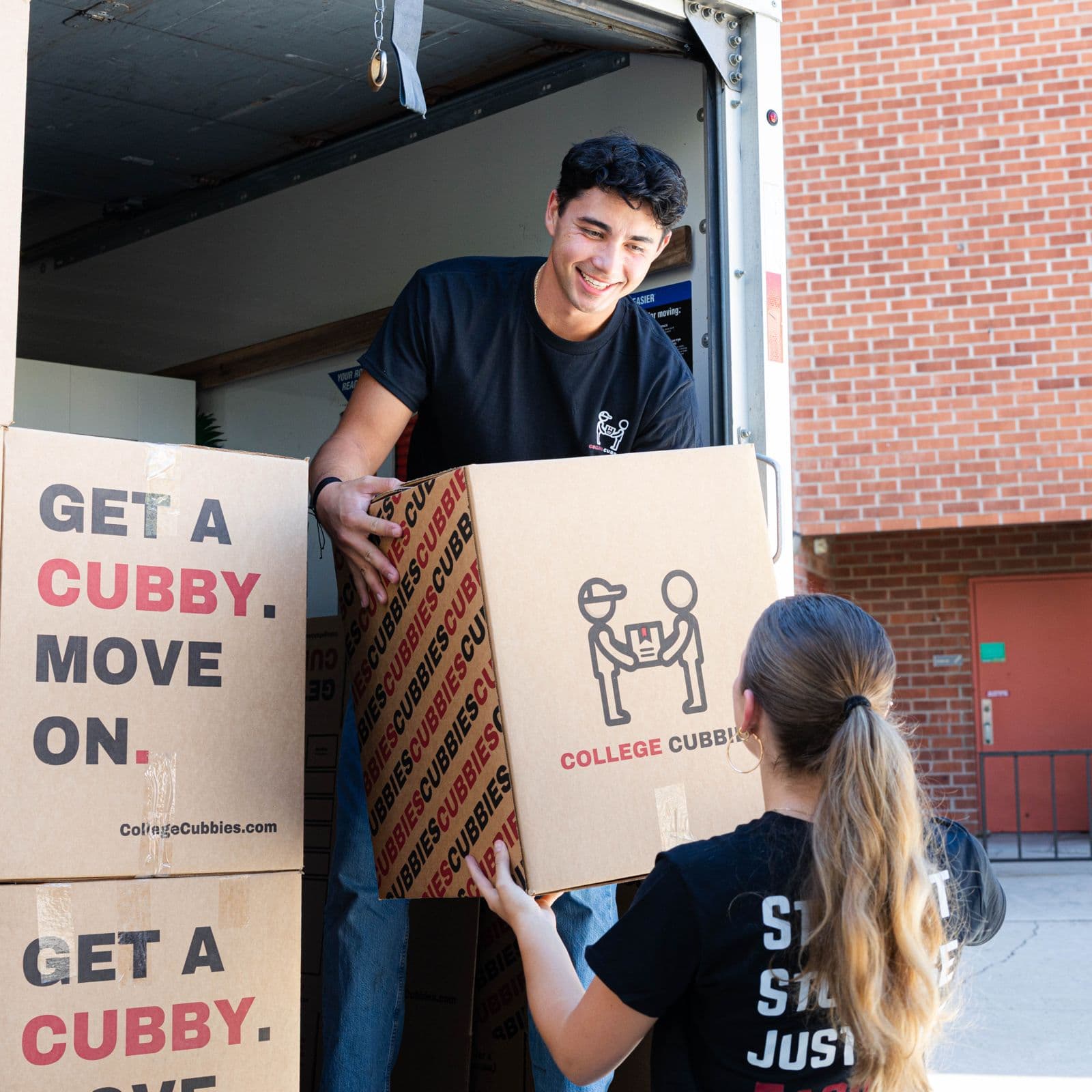 Crew handing off a Cubbies box at the truck