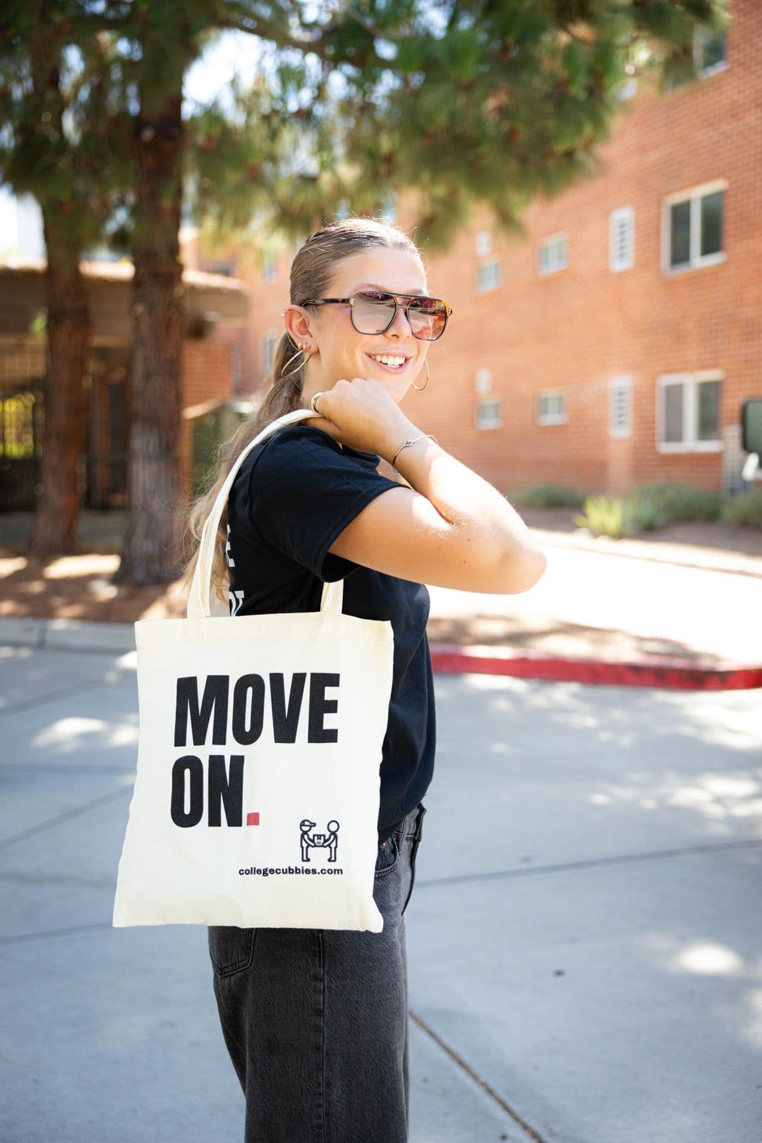 Student on campus with a College Cubbies tote