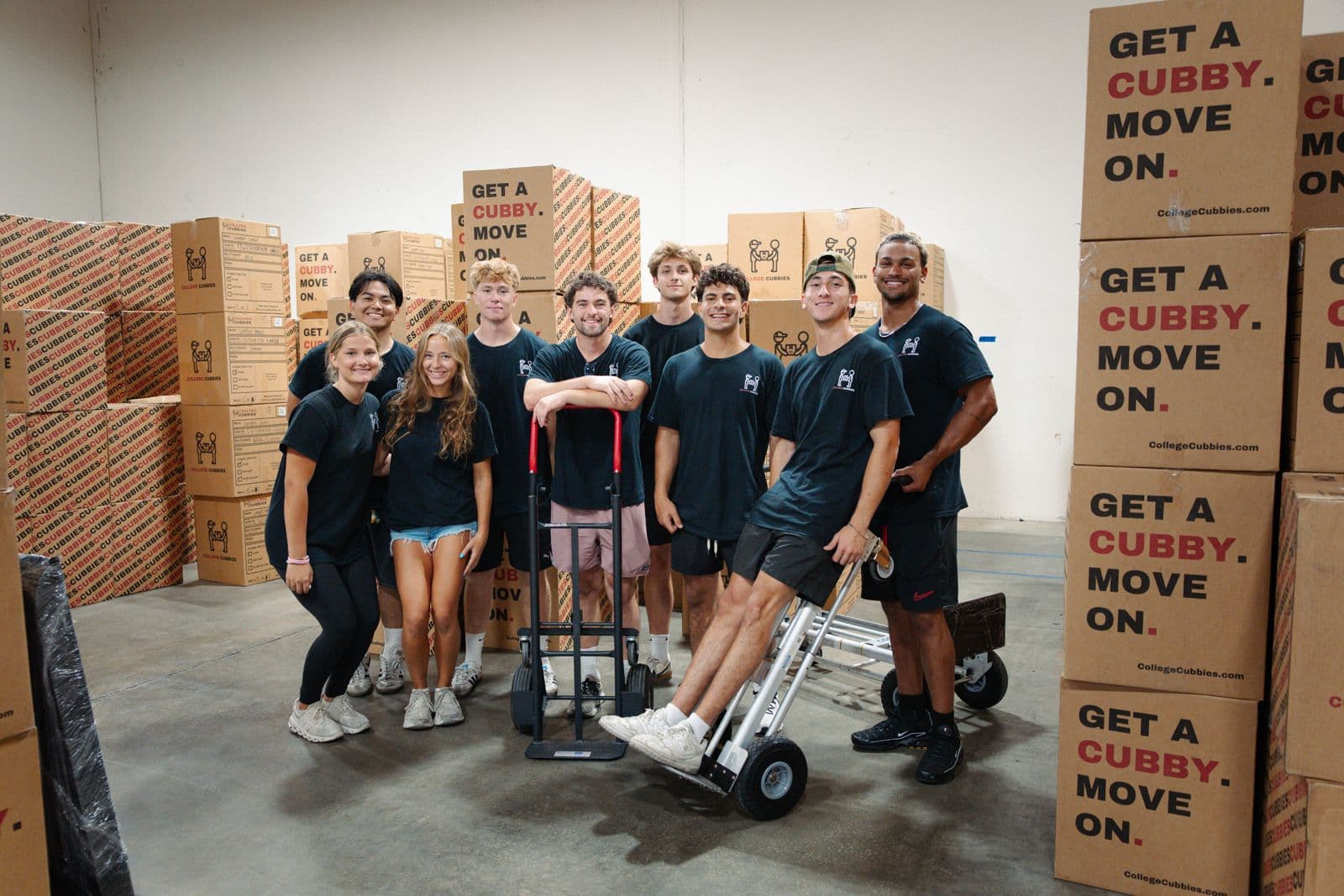 The full College Cubbies team in the warehouse